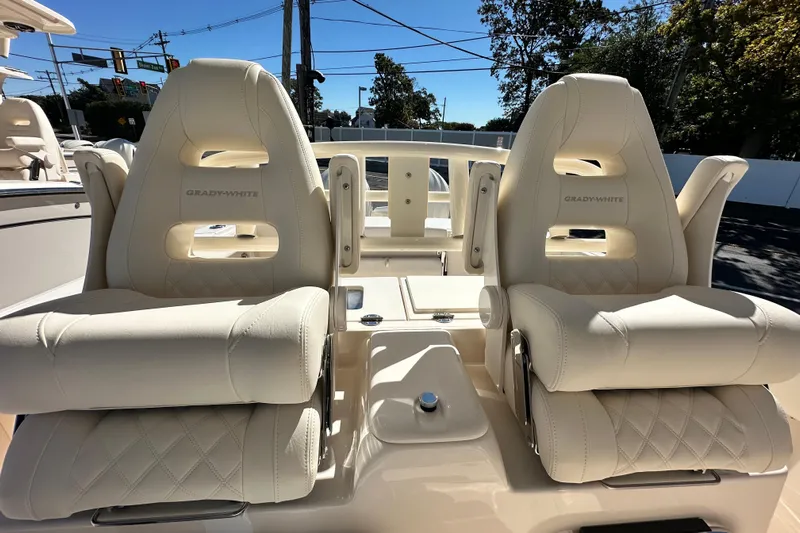  Yacht Photos Pics 2026 Grady-White Canyon 306 boat seats, luxurious white leather, outdoor setting.