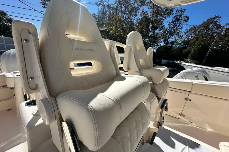  Yacht Photos Pics 2026 Grady-White Canyon 306 boat seats, luxurious white leather, outdoor setting.