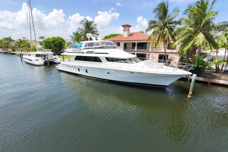 Family Time Yacht Photos Pics Luxury 2006 Cheoy Lee 84 Bravo yacht docked by palm trees and waterfront homes.