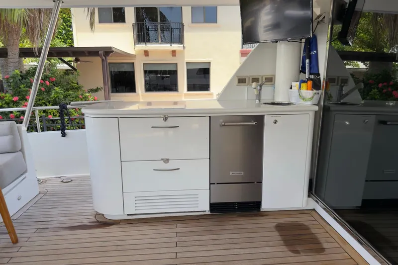 Family Time Yacht Photos Pics Outdoor kitchen on 2006 Cheoy Lee 84 Bravo yacht with sink and storage.