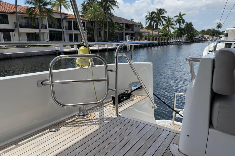 Family Time Yacht Photos Pics 2006 Cheoy Lee 84 Bravo yacht deck with waterfront view and palm trees.