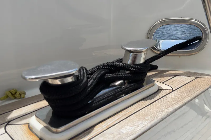 Family Time Yacht Photos Pics Cleat with black rope on 2006 Cheoy Lee 84 Bravo yacht deck.