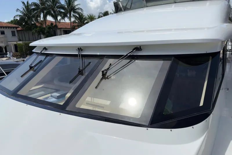 Family Time Yacht Photos Pics 2006 Cheoy Lee 84 Bravo yacht with sleek windshield design and wipers, docked near palm trees.