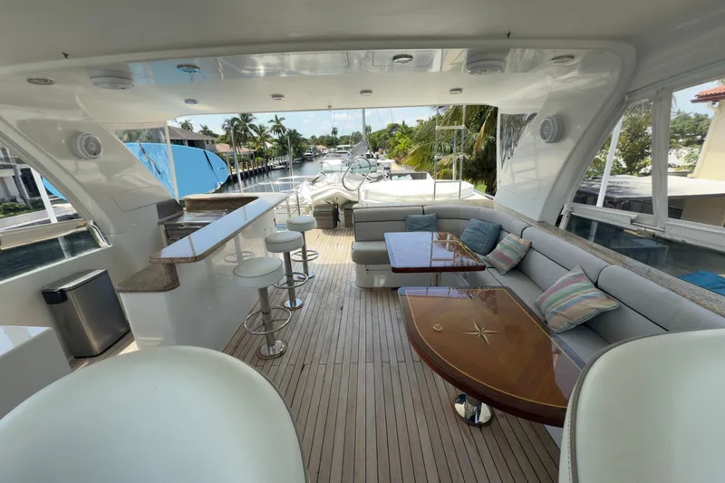 Family Time Yacht Photos Pics Luxurious 2006 Cheoy Lee 84 Bravo yacht interior with seating, bar, and scenic canal view.