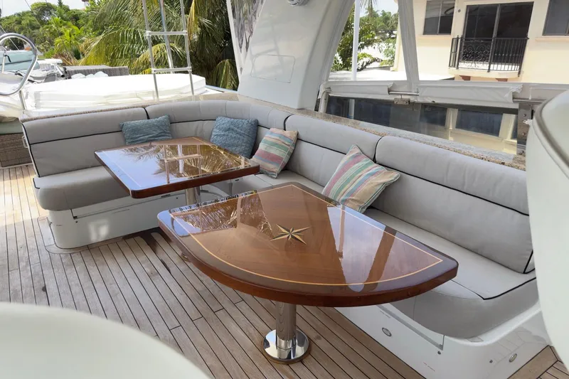 Family Time Yacht Photos Pics Luxurious 2006 Cheoy Lee 84 Bravo yacht deck with elegant seating and polished wooden tables.