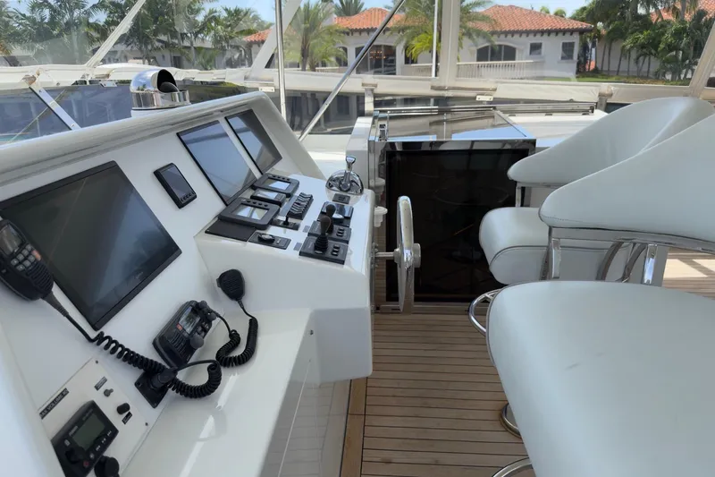 Family Time Yacht Photos Pics Helm station of 2006 Cheoy Lee 84 Bravo yacht with modern controls and seating.