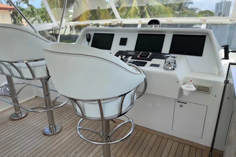 Family Time Yacht Photos Pics Helm of 2006 Cheoy Lee 84 Bravo yacht with modern controls and seating.