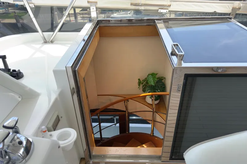 Family Time Yacht Photos Pics Staircase on 2006 Cheoy Lee 84 Bravo yacht with sleek design and potted plant.