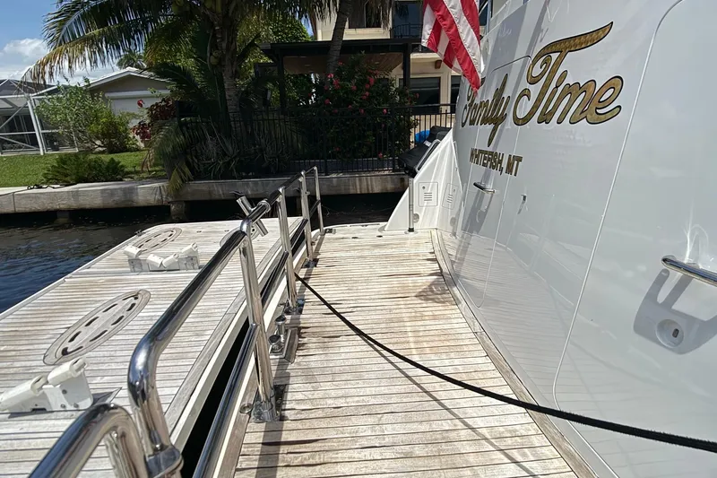 Family Time Yacht Photos Pics 2006 Cheoy Lee 84 Bravo yacht docked, featuring "Family Time" name and American flag.