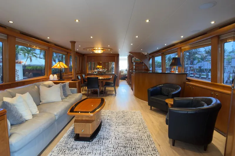 Family Time Yacht Photos Pics Luxurious interior of 2006 Cheoy Lee 84 Bravo yacht with elegant furnishings and large windows.