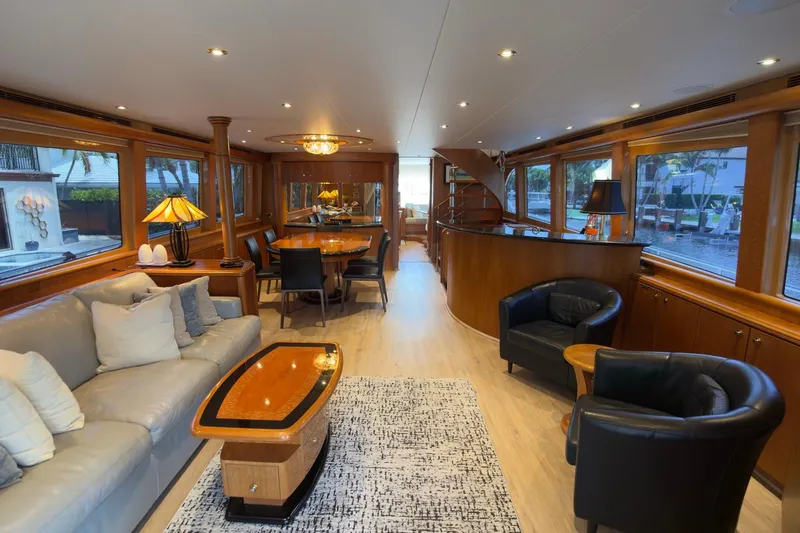 Family Time Yacht Photos Pics Luxurious interior of 2006 Cheoy Lee 84 Bravo yacht with elegant furnishings and large windows.