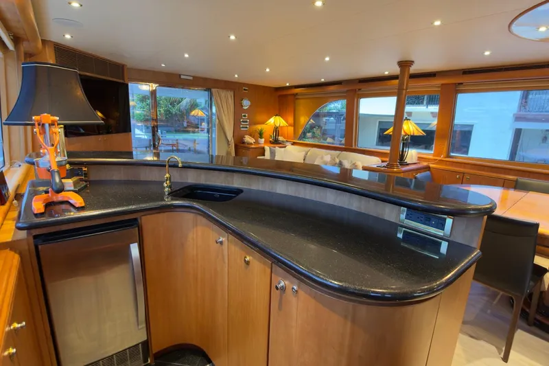 Family Time Yacht Photos Pics Luxurious interior of 2006 Cheoy Lee 84 Bravo yacht with elegant bar and seating area.