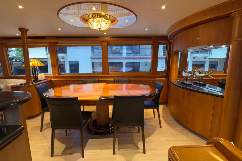 Family Time Yacht Photos Pics Luxurious dining area on 2006 Cheoy Lee 84 Bravo yacht with elegant wood finishes.