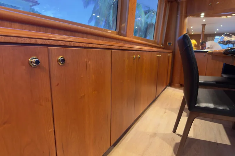 Family Time Yacht Photos Pics Luxurious wooden interior of 2006 Cheoy Lee 84 Bravo yacht, featuring elegant cabinetry and seating.