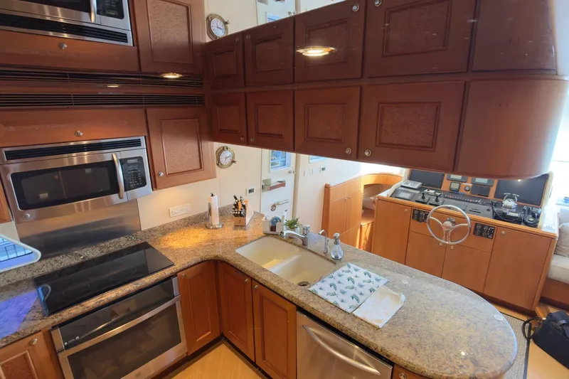 Family Time Yacht Photos Pics Luxurious kitchen interior of 2006 Cheoy Lee 84 Bravo yacht with modern appliances.