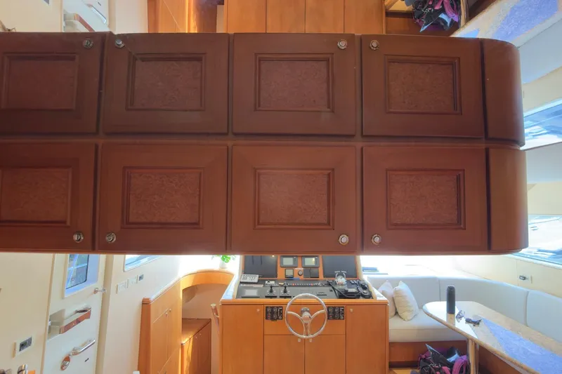 Family Time Yacht Photos Pics Interior of 2006 Cheoy Lee 84 Bravo yacht with wooden cabinetry and helm station.