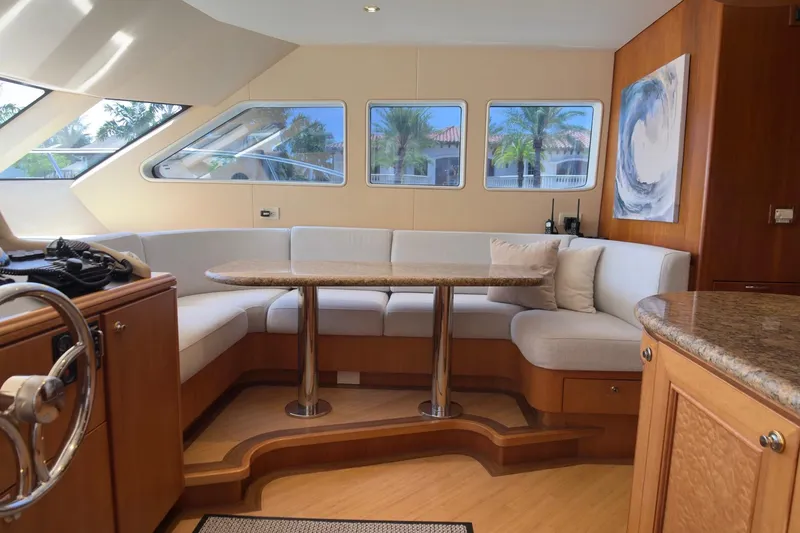 Family Time Yacht Photos Pics Luxurious interior of 2006 Cheoy Lee 84 Bravo yacht with elegant seating and panoramic windows.