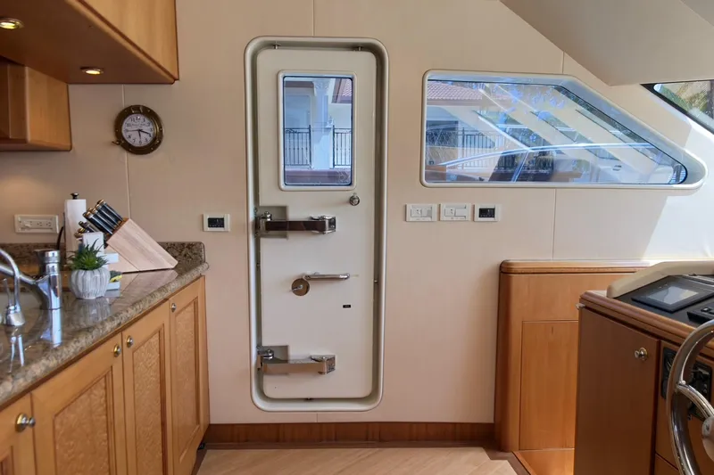 Family Time Yacht Photos Pics Interior of 2006 Cheoy Lee 84 Bravo yacht, featuring kitchen and secure door.