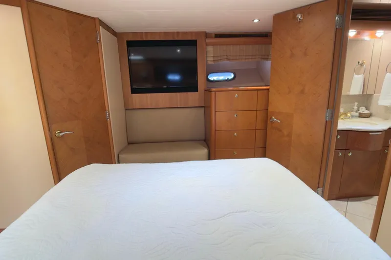 Family Time Yacht Photos Pics Luxurious cabin interior of 2006 Cheoy Lee 84 Bravo yacht with TV and ensuite bathroom.