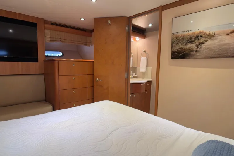 Family Time Yacht Photos Pics Luxurious 2006 Cheoy Lee 84 Bravo yacht bedroom with ensuite bathroom and elegant decor.