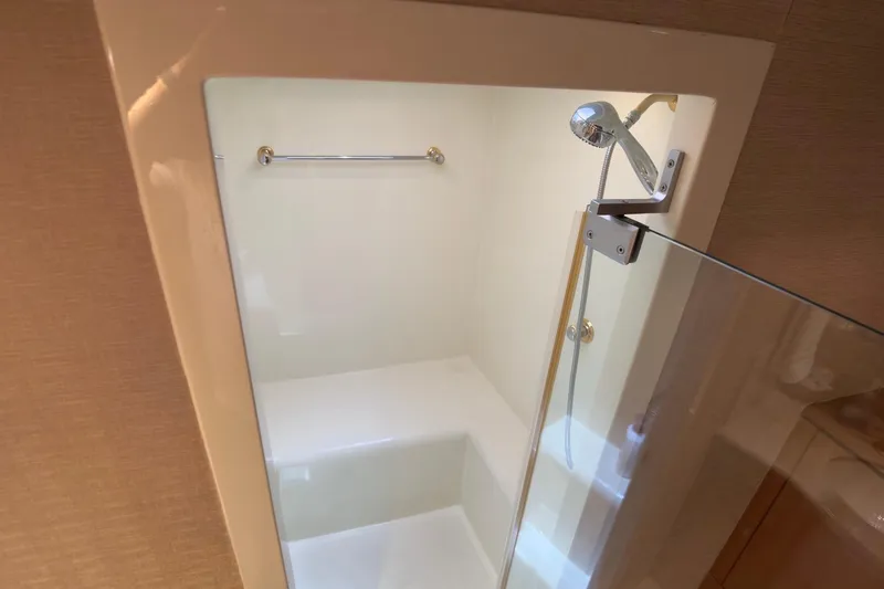 Family Time Yacht Photos Pics Shower area in 2006 Cheoy Lee 84 Bravo yacht with glass door and handheld showerhead.