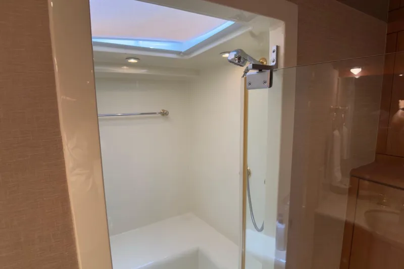 Family Time Yacht Photos Pics Shower area in 2006 Cheoy Lee 84 Bravo yacht with skylight and modern fixtures.