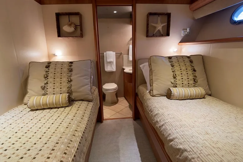 Family Time Yacht Photos Pics Luxurious twin cabin interior on 2006 Cheoy Lee 84 Bravo yacht, featuring elegant decor.