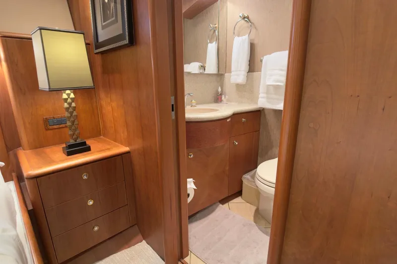 Family Time Yacht Photos Pics Luxurious 2006 Cheoy Lee 84 Bravo yacht interior with elegant wood cabinetry and modern bathroom.