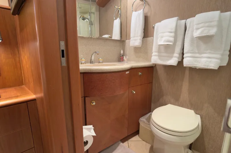 Family Time Yacht Photos Pics Luxurious bathroom in 2006 Cheoy Lee 84 Bravo yacht with wooden cabinetry and modern fixtures.