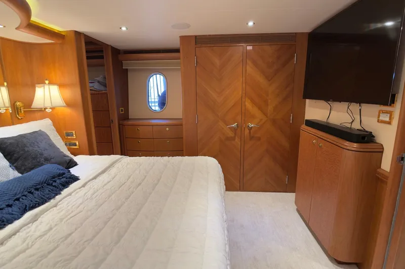 Family Time Yacht Photos Pics Luxurious 2006 Cheoy Lee 84 Bravo yacht bedroom with elegant wood finishes and modern amenities.