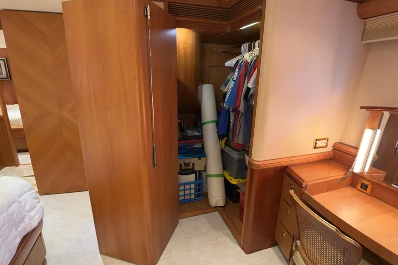 Family Time Yacht Photos Pics Luxurious wooden closet and desk area inside a 2006 Cheoy Lee 84 Bravo yacht.