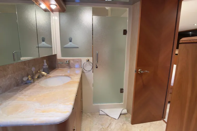 Family Time Yacht Photos Pics Luxurious bathroom in 2006 Cheoy Lee 84 Bravo yacht with marble countertop and frosted glass shower.