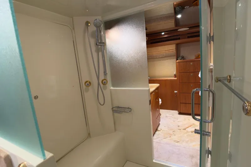 Family Time Yacht Photos Pics Luxurious bathroom in 2006 Cheoy Lee 84 Bravo yacht with shower and wooden cabinetry.