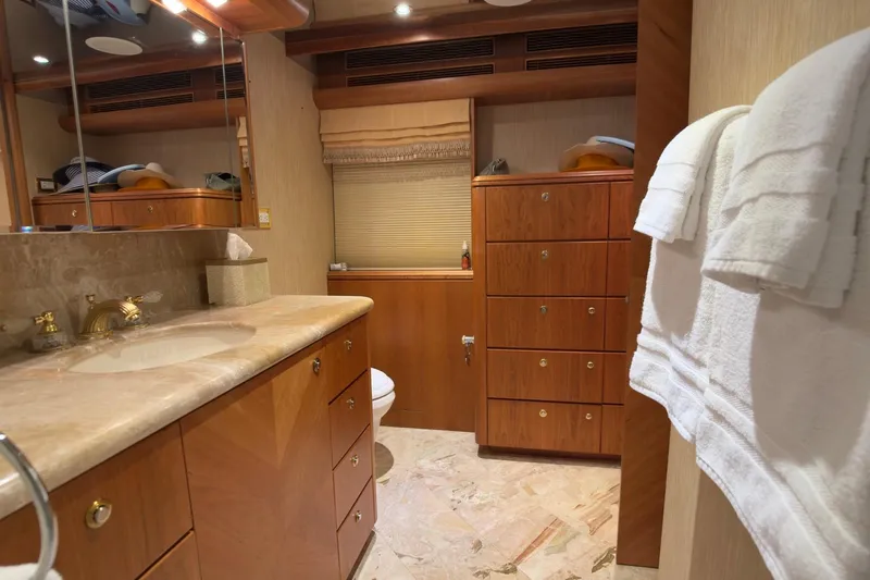 Family Time Yacht Photos Pics Luxurious bathroom interior of 2006 Cheoy Lee 84 Bravo yacht with wooden cabinetry.