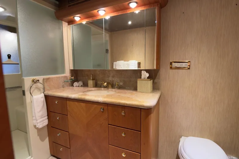 Family Time Yacht Photos Pics Luxurious bathroom in 2006 Cheoy Lee 84 Bravo yacht with elegant wood cabinetry.