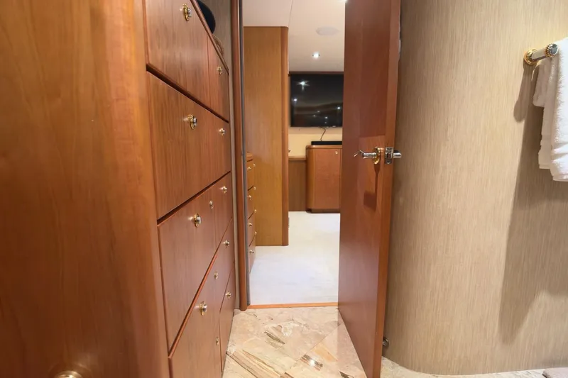 Family Time Yacht Photos Pics Luxurious interior of 2006 Cheoy Lee 84 Bravo yacht, featuring wooden cabinetry and elegant design.