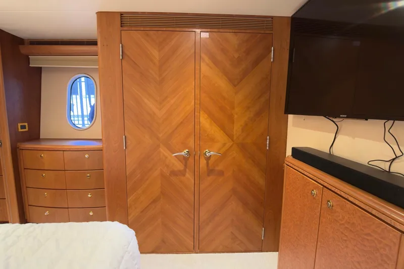 Family Time Yacht Photos Pics Luxurious interior of 2006 Cheoy Lee 84 Bravo yacht with wood cabinetry and porthole window.