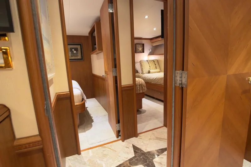 Family Time Yacht Photos Pics Luxurious interior of 2006 Cheoy Lee 84 Bravo yacht, featuring elegant wood finishes and cozy bedrooms.