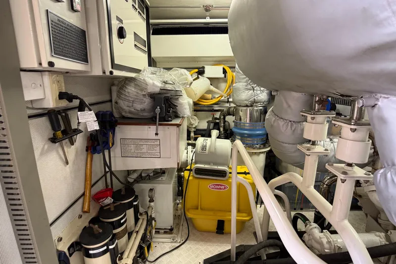 Family Time Yacht Photos Pics Engine room of 2006 Cheoy Lee 84 Bravo yacht, featuring equipment and tools.