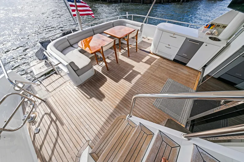 Family Time Yacht Photos Pics Luxurious 2006 Cheoy Lee 84 Bravo yacht deck with seating and dining area.