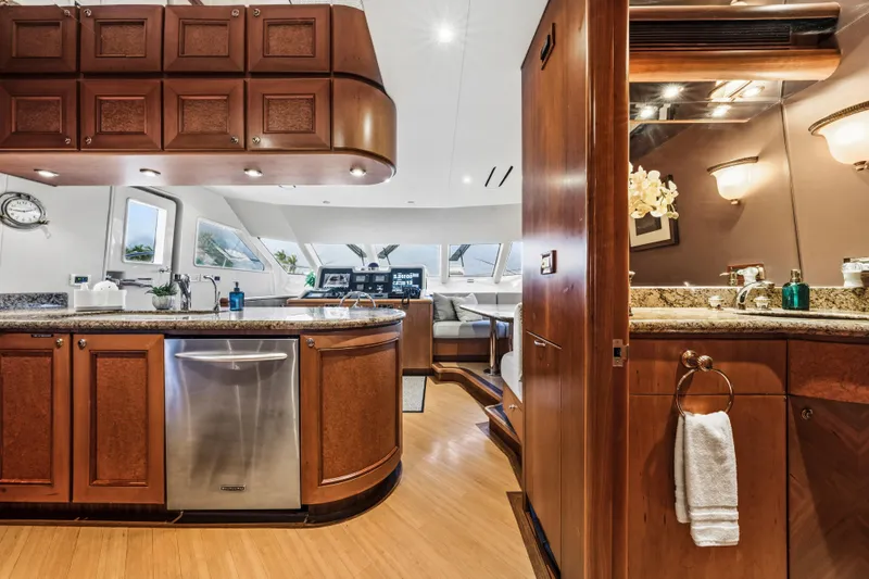 Family Time Yacht Photos Pics Luxurious interior of 2006 Cheoy Lee 84 Bravo yacht with elegant wood finishes and modern amenities.