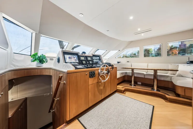 Family Time Yacht Photos Pics Luxurious interior of 2006 Cheoy Lee 84 Bravo yacht with helm and seating area.