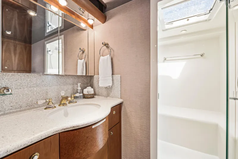 Family Time Yacht Photos Pics Luxurious bathroom in 2006 Cheoy Lee 84 Bravo yacht with elegant fixtures and skylight.