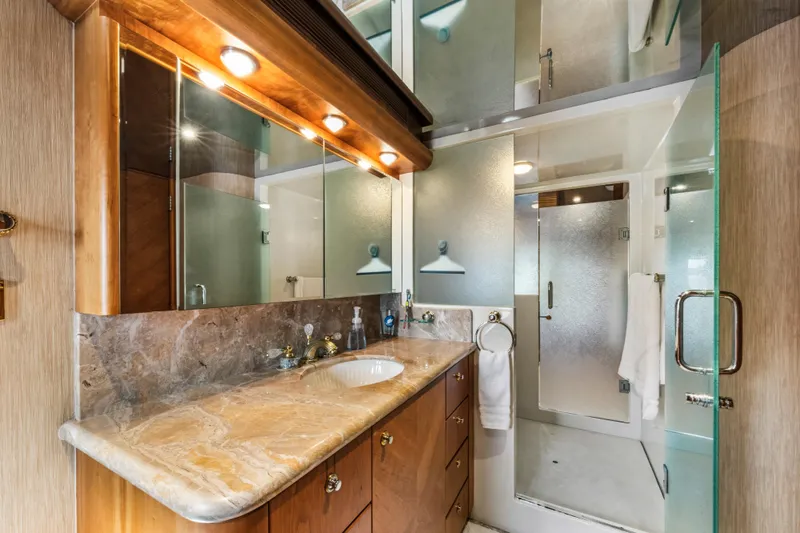 Family Time Yacht Photos Pics Luxurious bathroom in 2006 Cheoy Lee 84 Bravo yacht with marble countertop and glass shower.