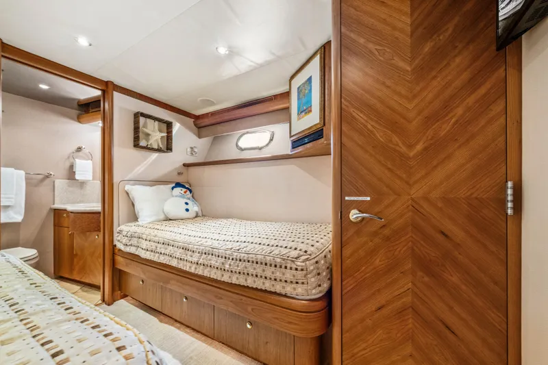 Family Time Yacht Photos Pics Luxurious 2006 Cheoy Lee 84 Bravo yacht cabin with cozy bed and elegant wood finishes.
