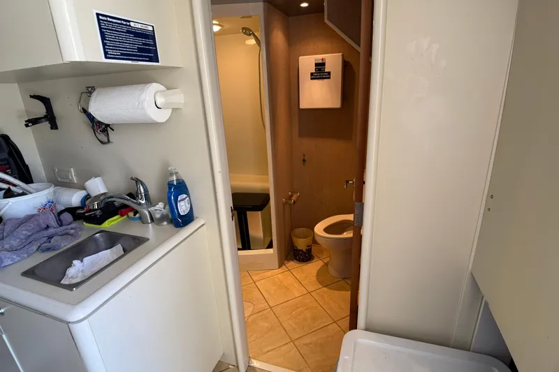 Family Time Yacht Photos Pics Bathroom and sink area on 2006 Cheoy Lee 84 Bravo yacht, featuring modern amenities.