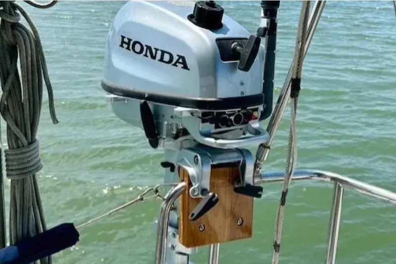Valanta Yacht Photos Pics Honda outboard motor mounted on a 2007 Hanse 400 sailboat, with water in the background.