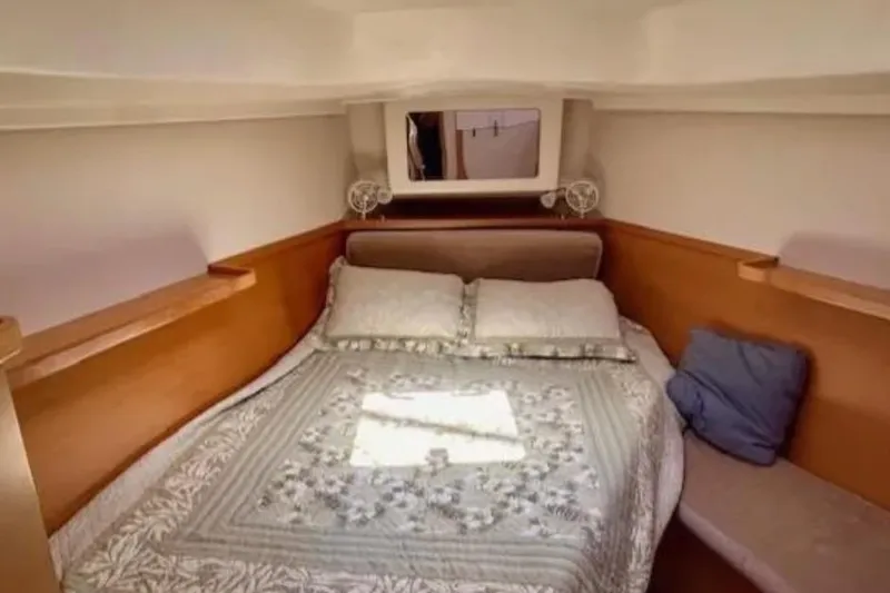 Valanta Yacht Photos Pics Cozy cabin interior of 2007 Hanse 400 yacht with double bed and wooden accents.