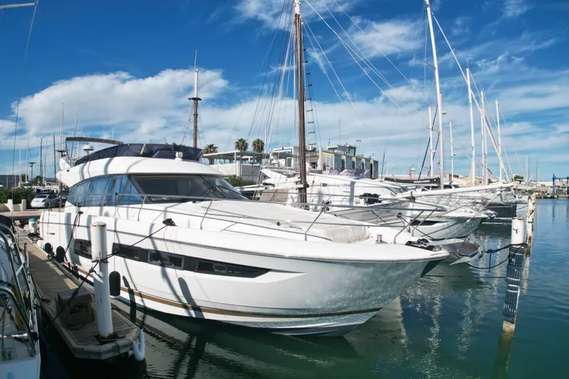  Yacht Photos Pics 2017 Prestige 560 Fly yacht docked at marina under blue sky.