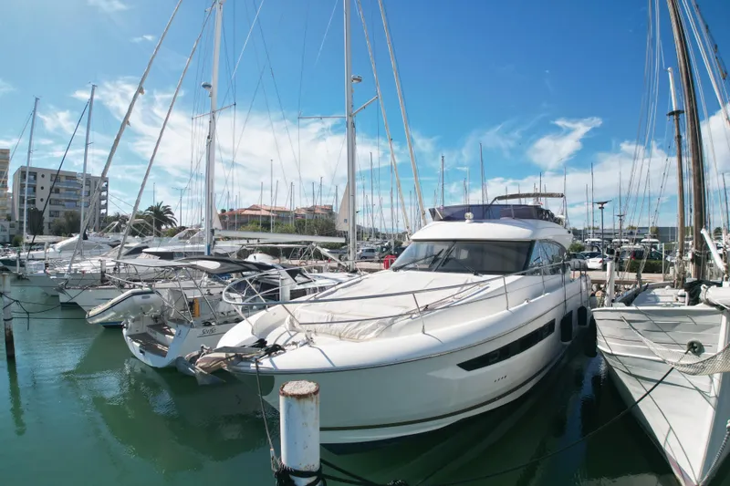  Yacht Photos Pics Prestige 560 Fly 2017 yacht docked in a marina under a clear blue sky.
